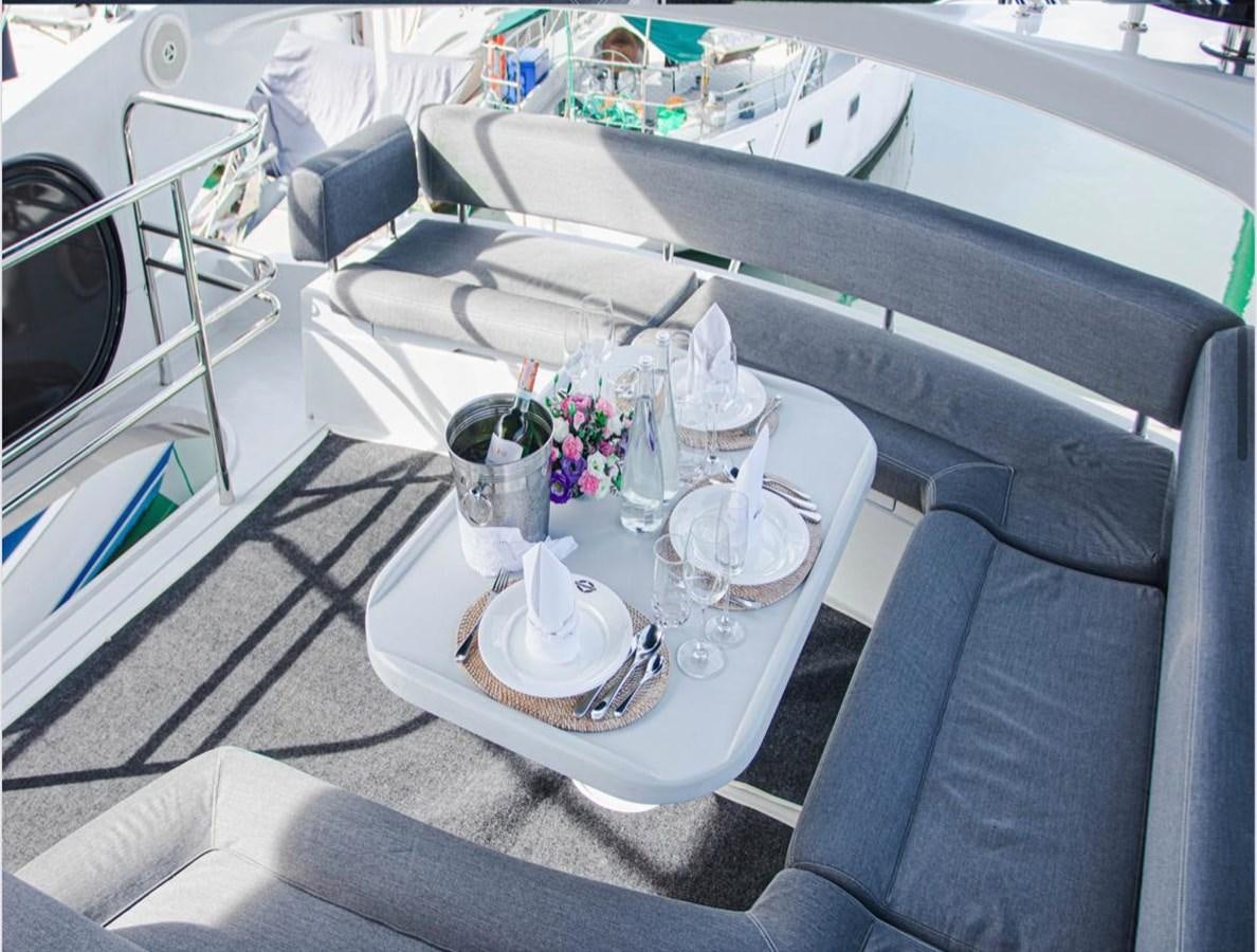 a table with a plate and glasses on it aboard 2012 SUNSEEKER MANHATTAN 63 Yacht for Sale