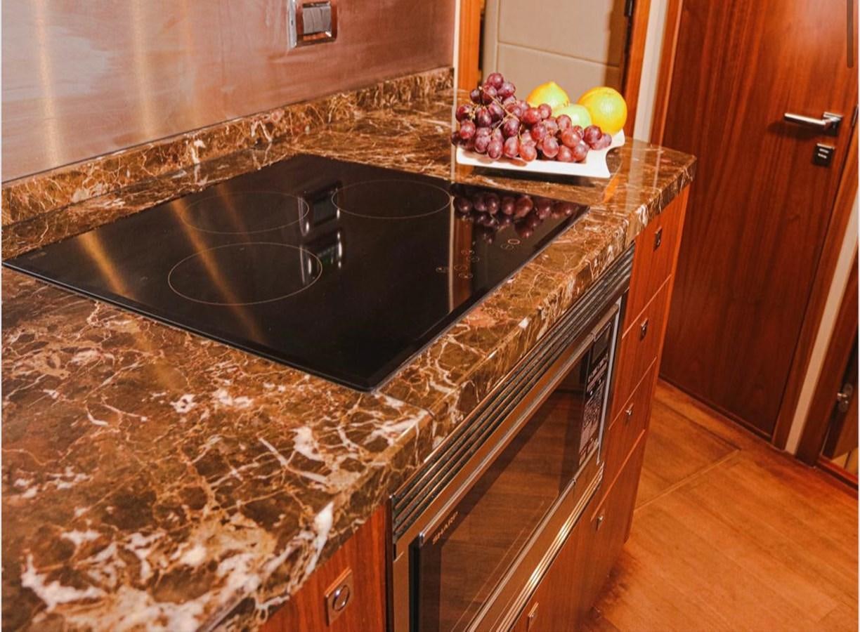 a kitchen with marble counter tops aboard 2012 SUNSEEKER MANHATTAN 63 Yacht for Sale