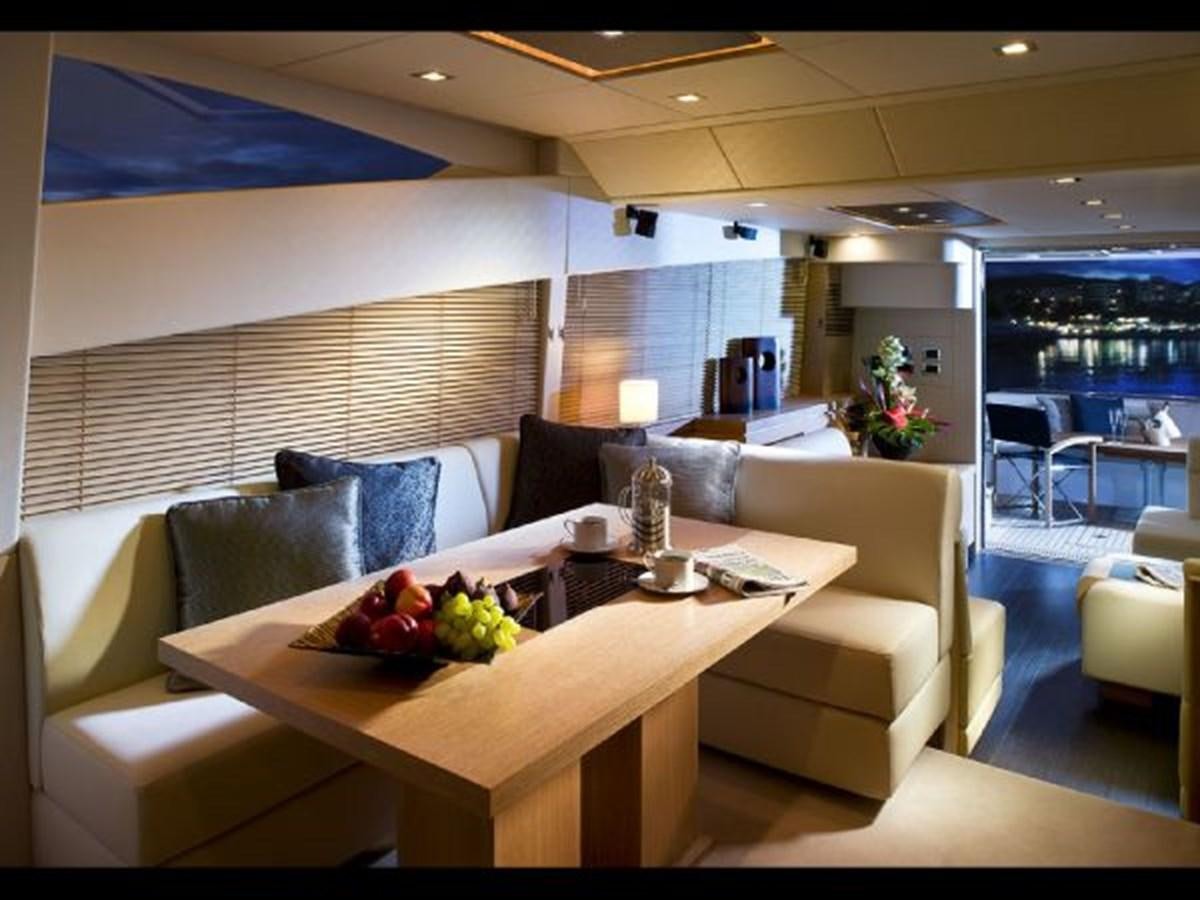 a modern living room with a large white table and chairs aboard 2012 SUNSEEKER MANHATTAN 63 Yacht for Sale