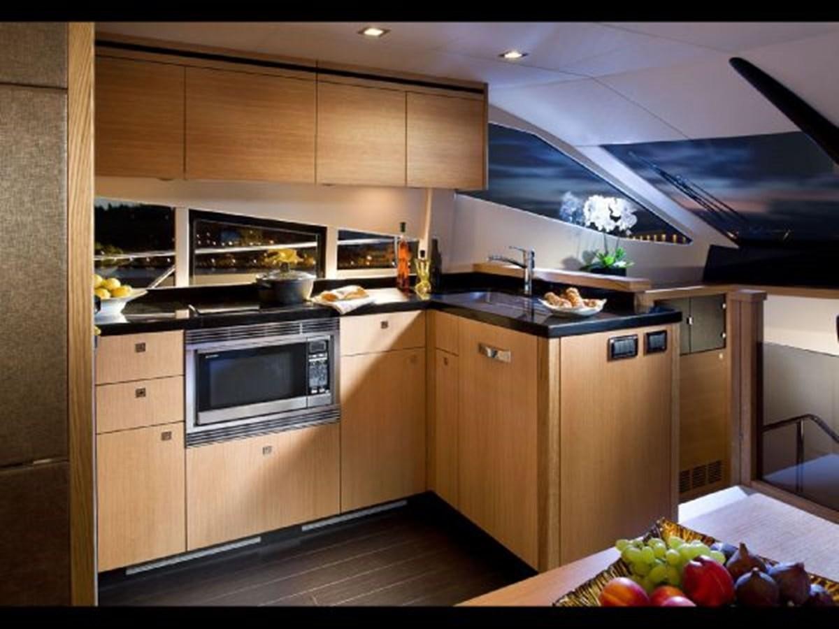 a kitchen with wooden cabinets aboard 2012 SUNSEEKER MANHATTAN 63 Yacht for Sale