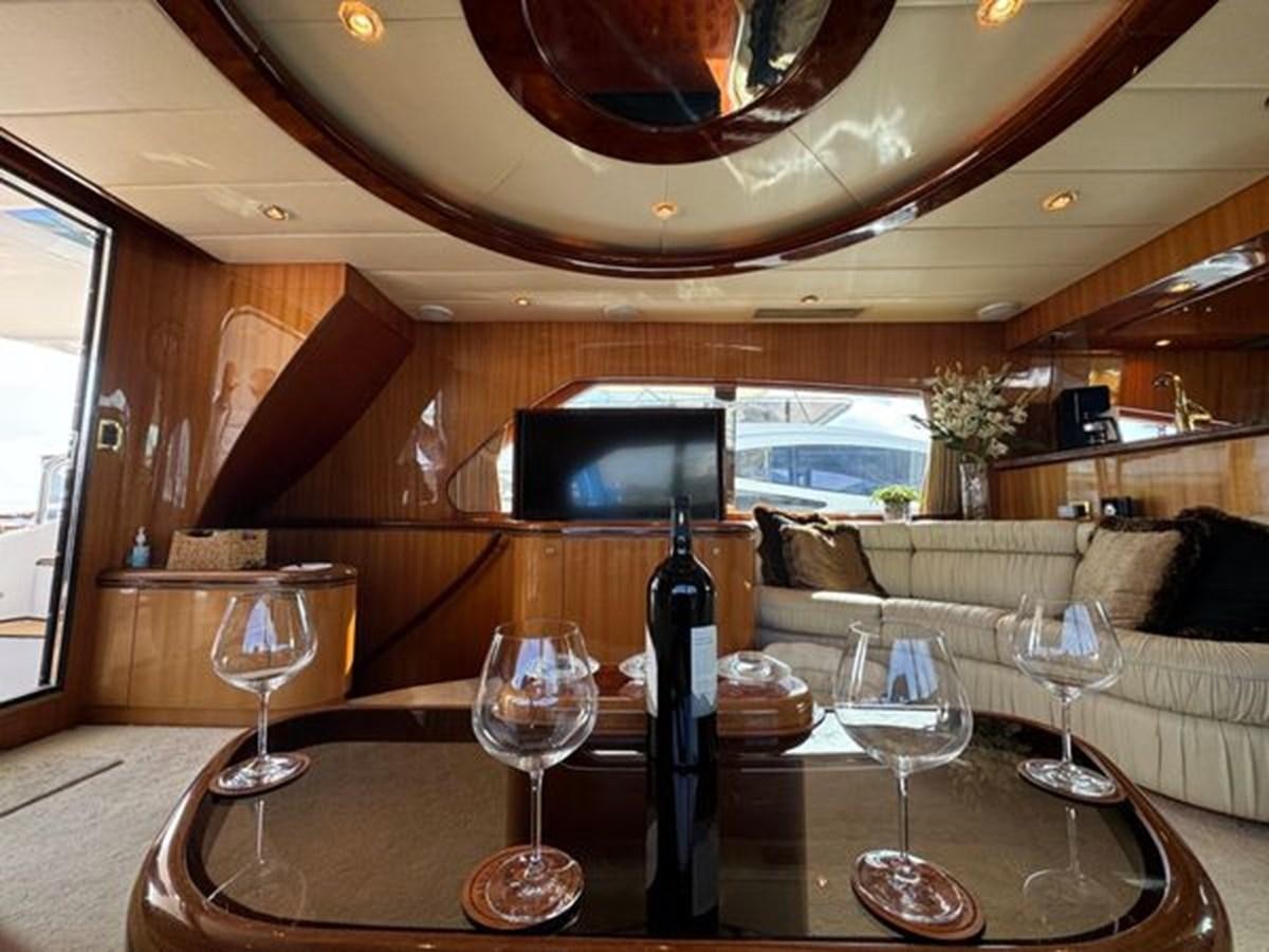 a wine bottle on a table aboard CLASSIFIED Yacht for Sale