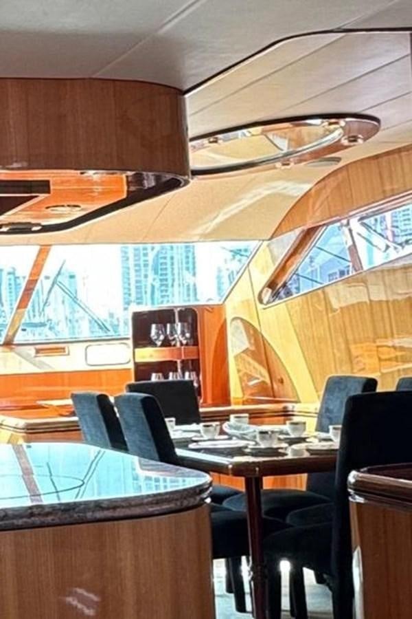 a room with tables and chairs aboard CLASSIFIED Yacht for Sale