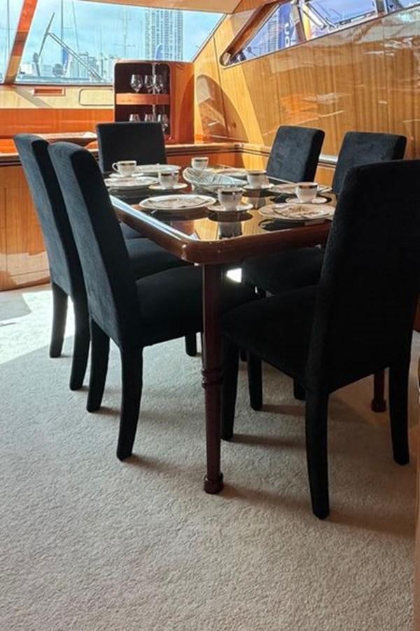 a table with chairs around it aboard CLASSIFIED Yacht for Sale