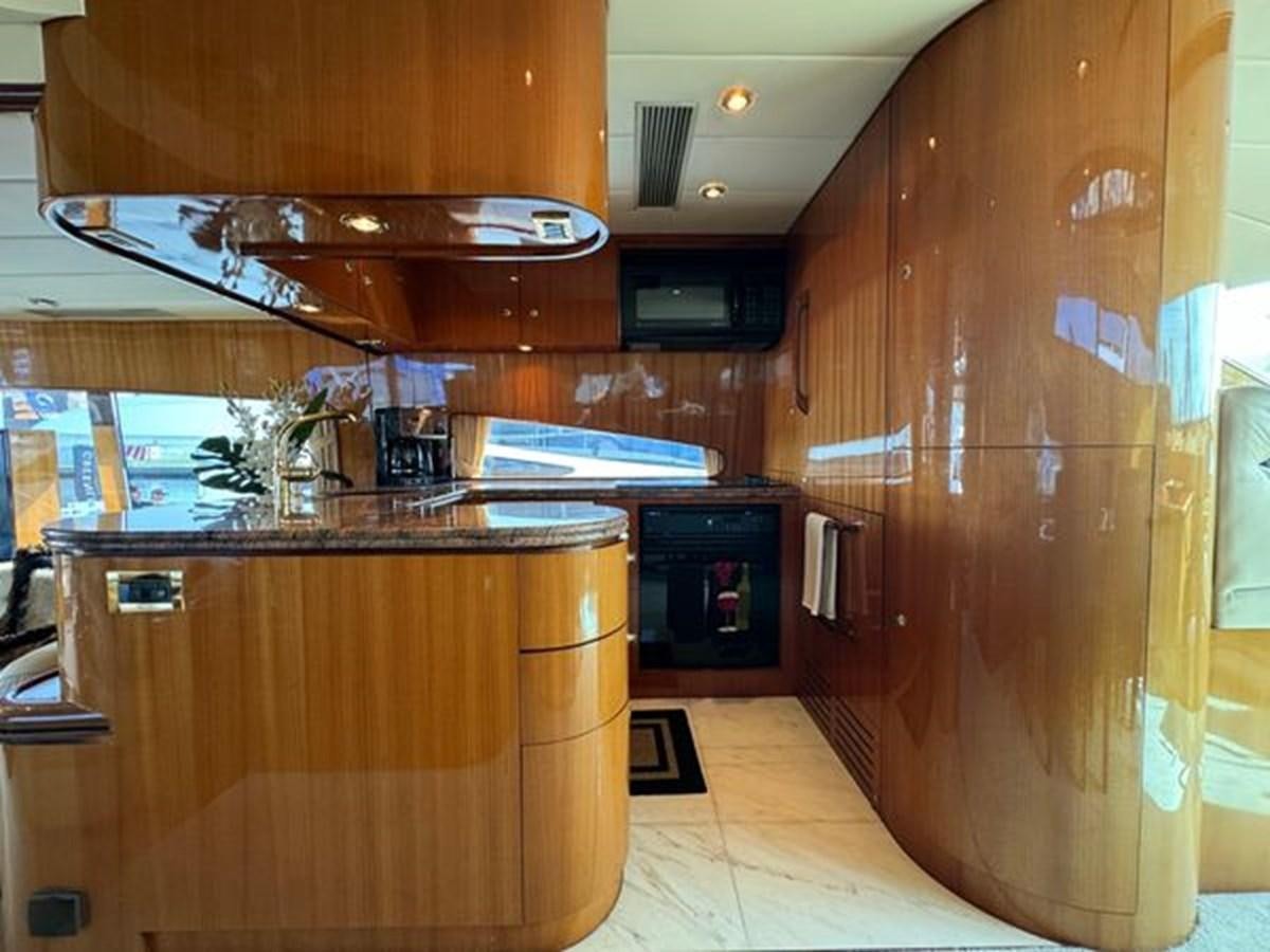 a kitchen with wooden cabinets aboard CLASSIFIED Yacht for Sale