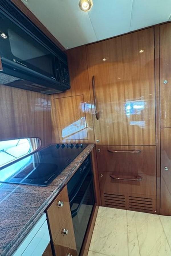 a kitchen with wooden cabinets aboard CLASSIFIED Yacht for Sale