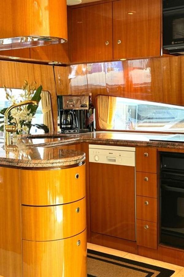 a kitchen with wooden cabinets aboard CLASSIFIED Yacht for Sale