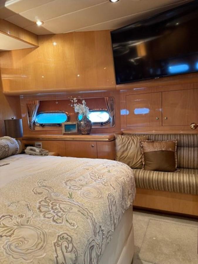 a bedroom with a bed and a television aboard CLASSIFIED Yacht for Sale