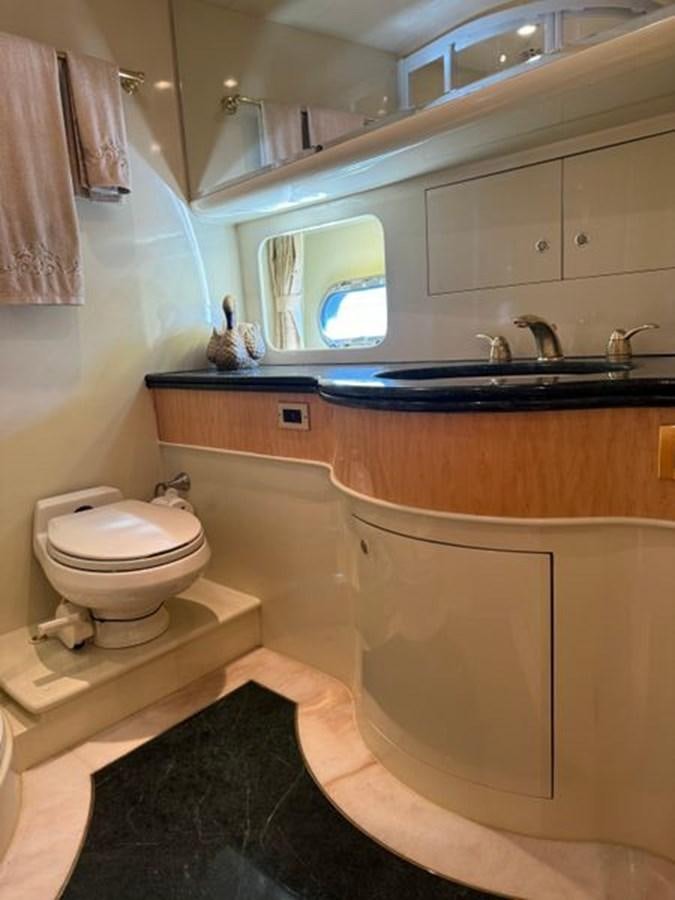 a bathroom with a toilet and a sink aboard CLASSIFIED Yacht for Sale