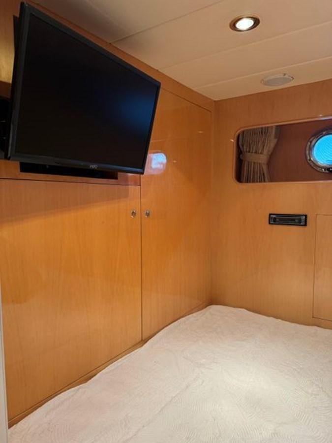 a tv on a wall aboard CLASSIFIED Yacht for Sale