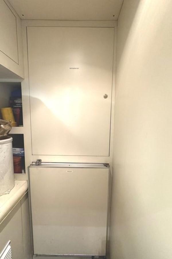 a white refrigerator in a kitchen aboard CLASSIFIED Yacht for Sale