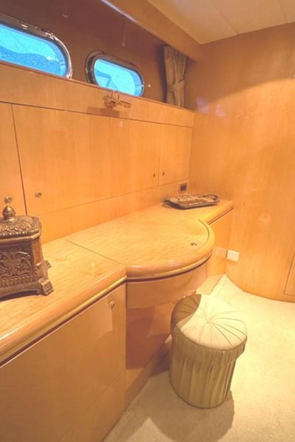 a bathroom with a toilet and a television on the wall aboard CLASSIFIED Yacht for Sale