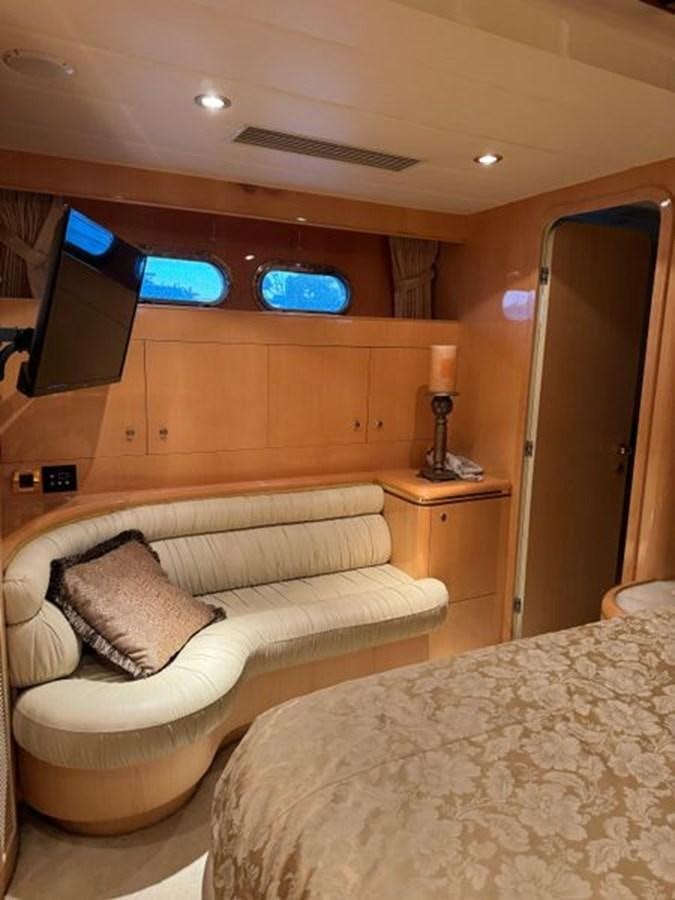 a room with a bed and a television aboard CLASSIFIED Yacht for Sale