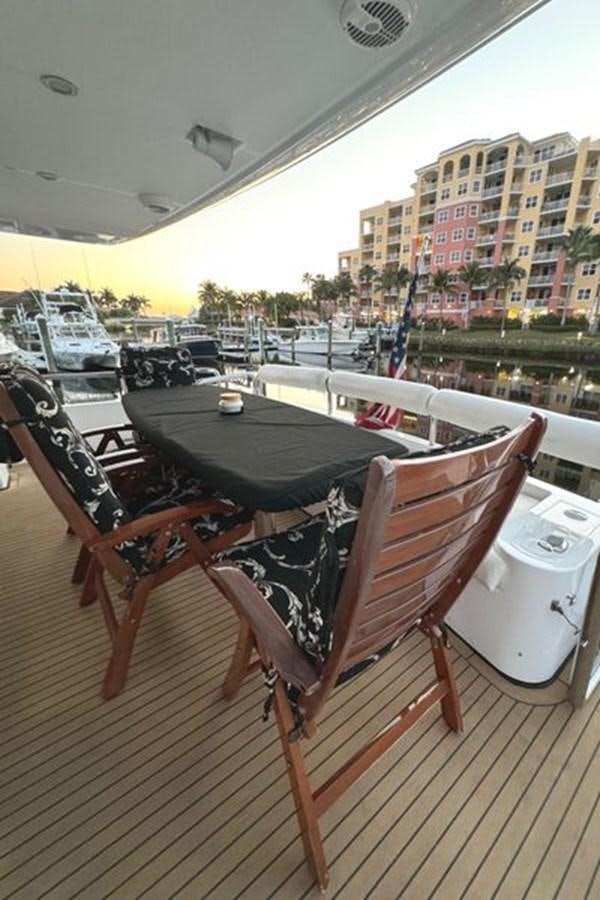 a table and chairs on a deck aboard CLASSIFIED Yacht for Sale