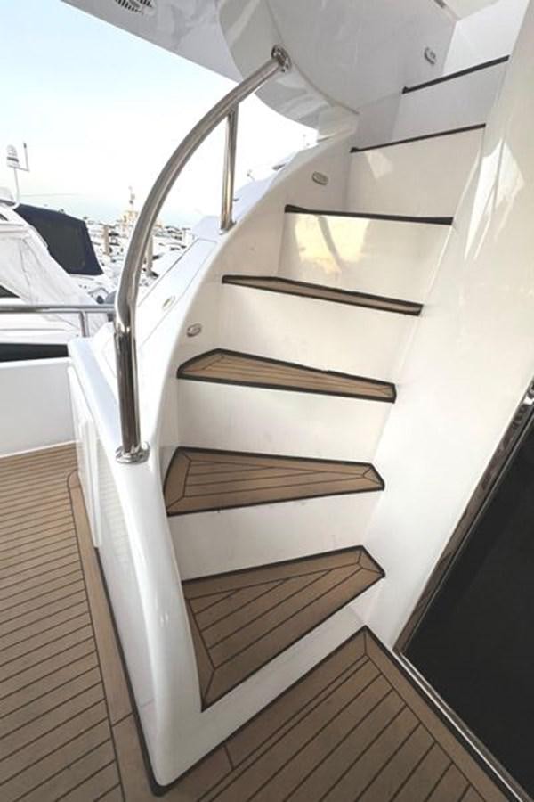 a white staircase with a metal railing aboard CLASSIFIED Yacht for Sale