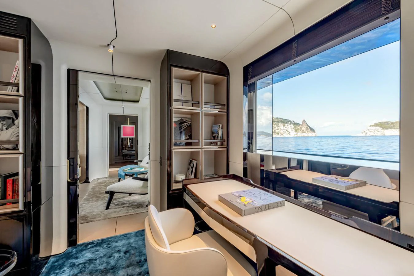 a room with a window and a desk with a view of the ocean aboard CLUB M Yacht for Sale