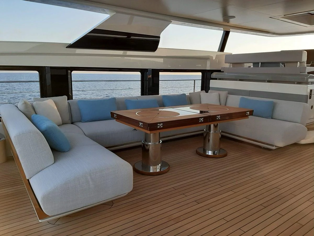 a living room with a couch and a table aboard CLUB M Yacht for Sale