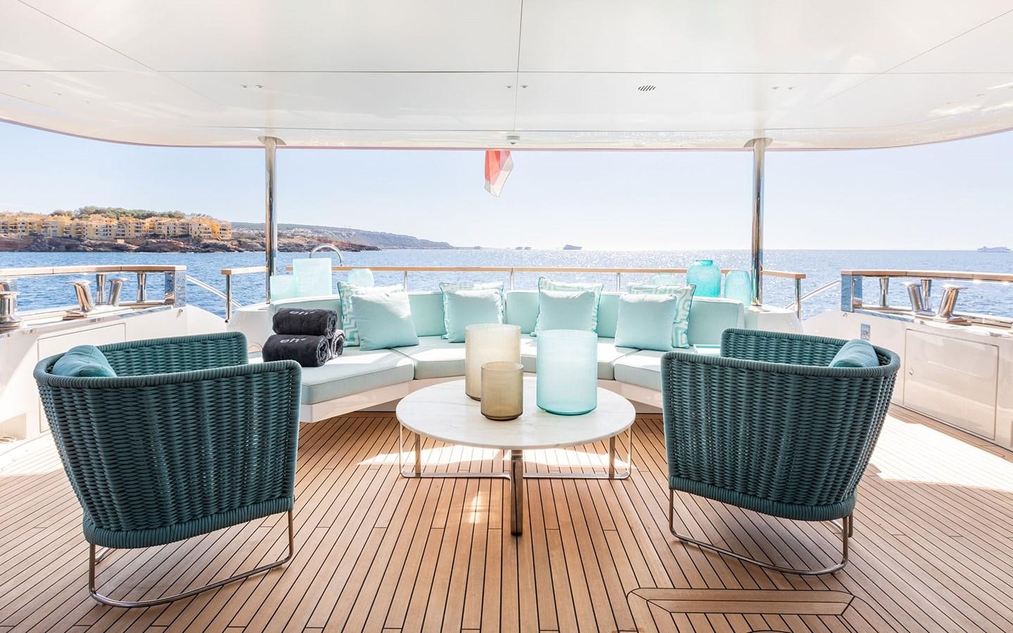 a table and chairs on a deck aboard EH2 Yacht for Sale