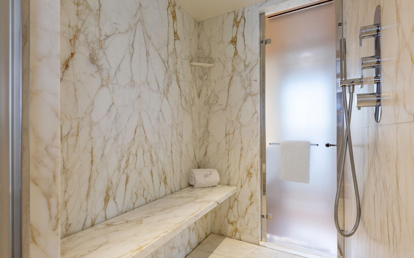 a bathroom with a shower curtain aboard EH2 Yacht for Sale