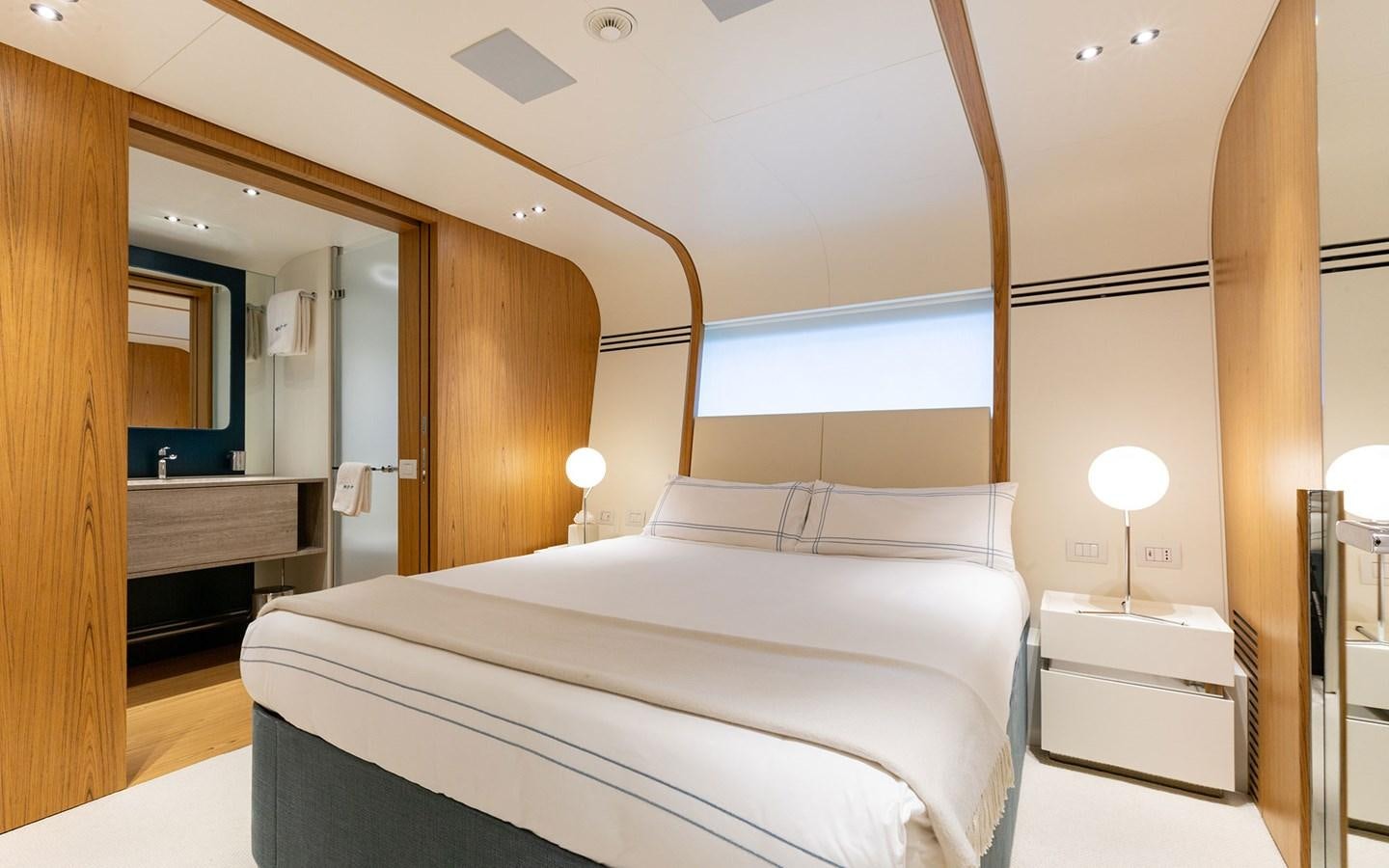 a bedroom with a bed and a mirror aboard EH2 Yacht for Sale
