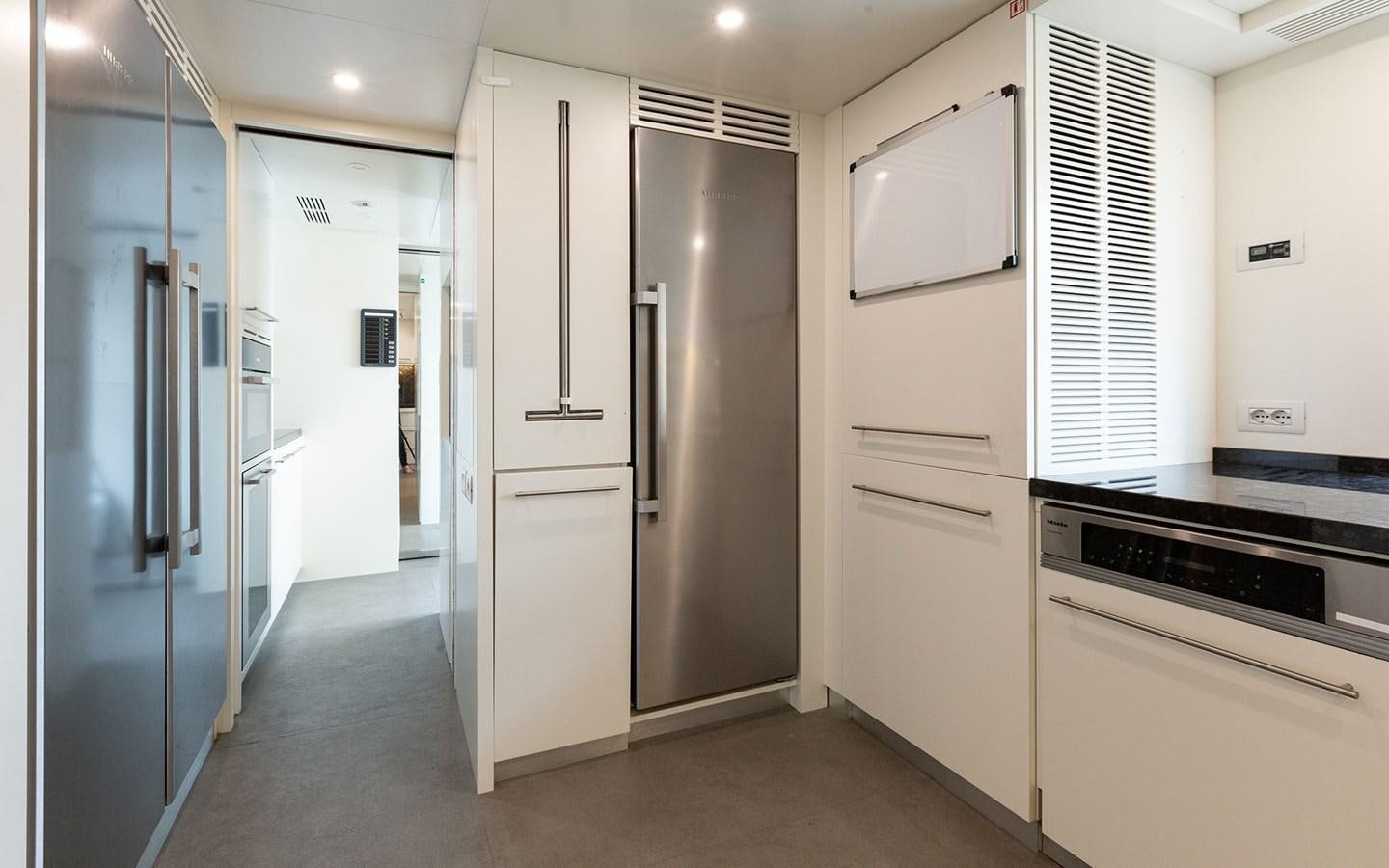 a kitchen with white cabinets aboard EH2 Yacht for Sale