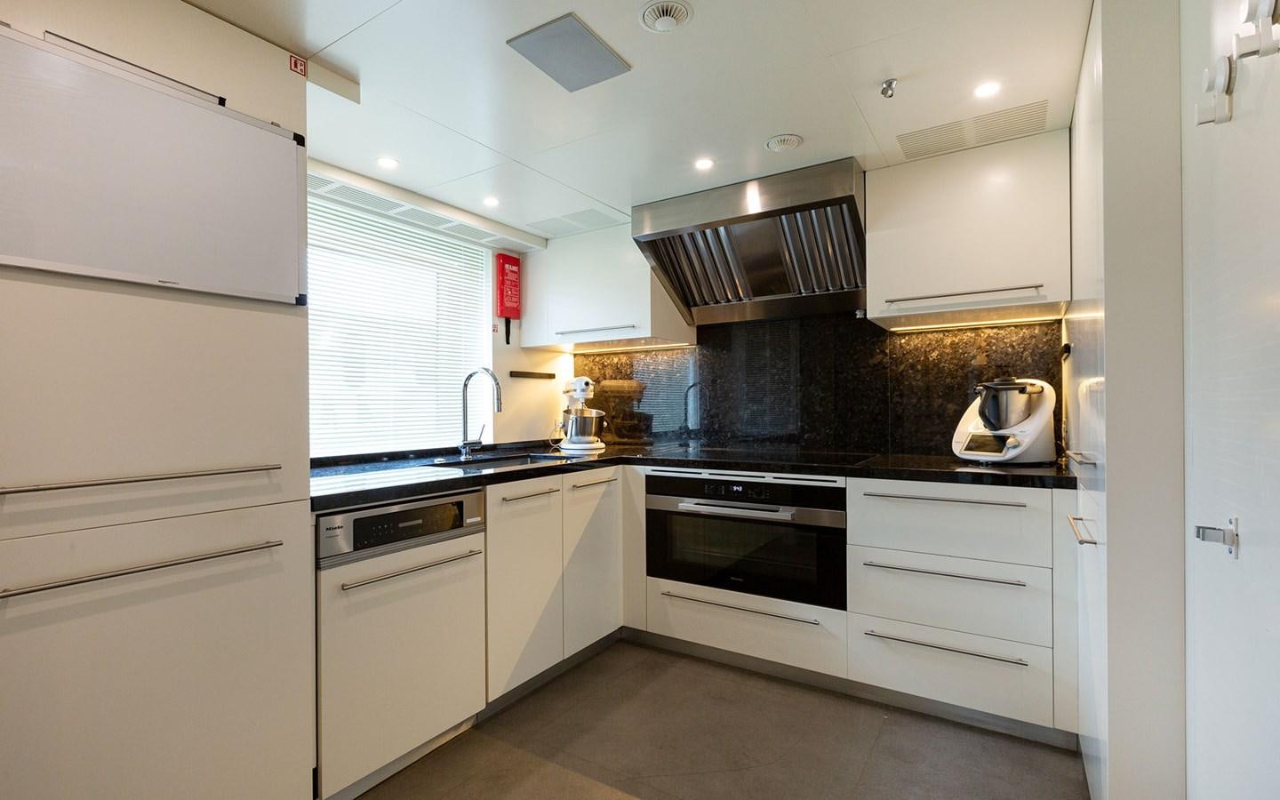 a kitchen with white cabinets aboard EH2 Yacht for Sale