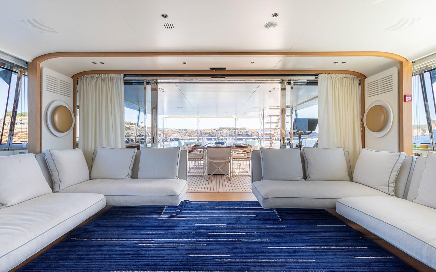 a large living room with a large window aboard EH2 Yacht for Sale