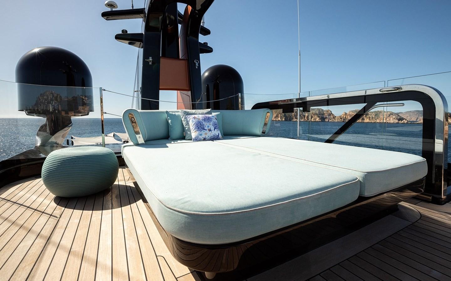 a white bed on a deck aboard EH2 Yacht for Sale
