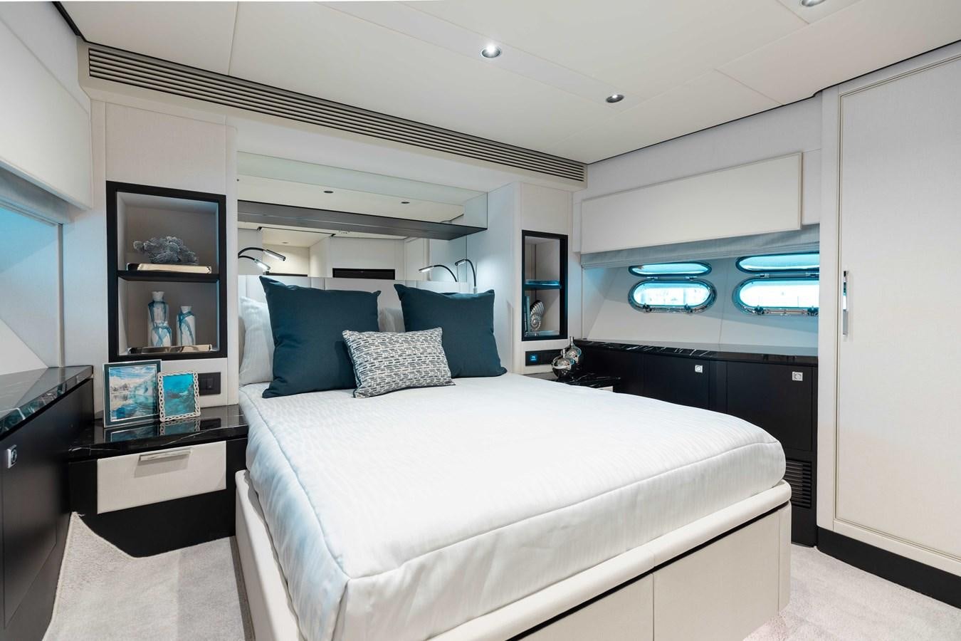 a bedroom with a bed and a desk aboard E90 MOTOR Yacht for Sale