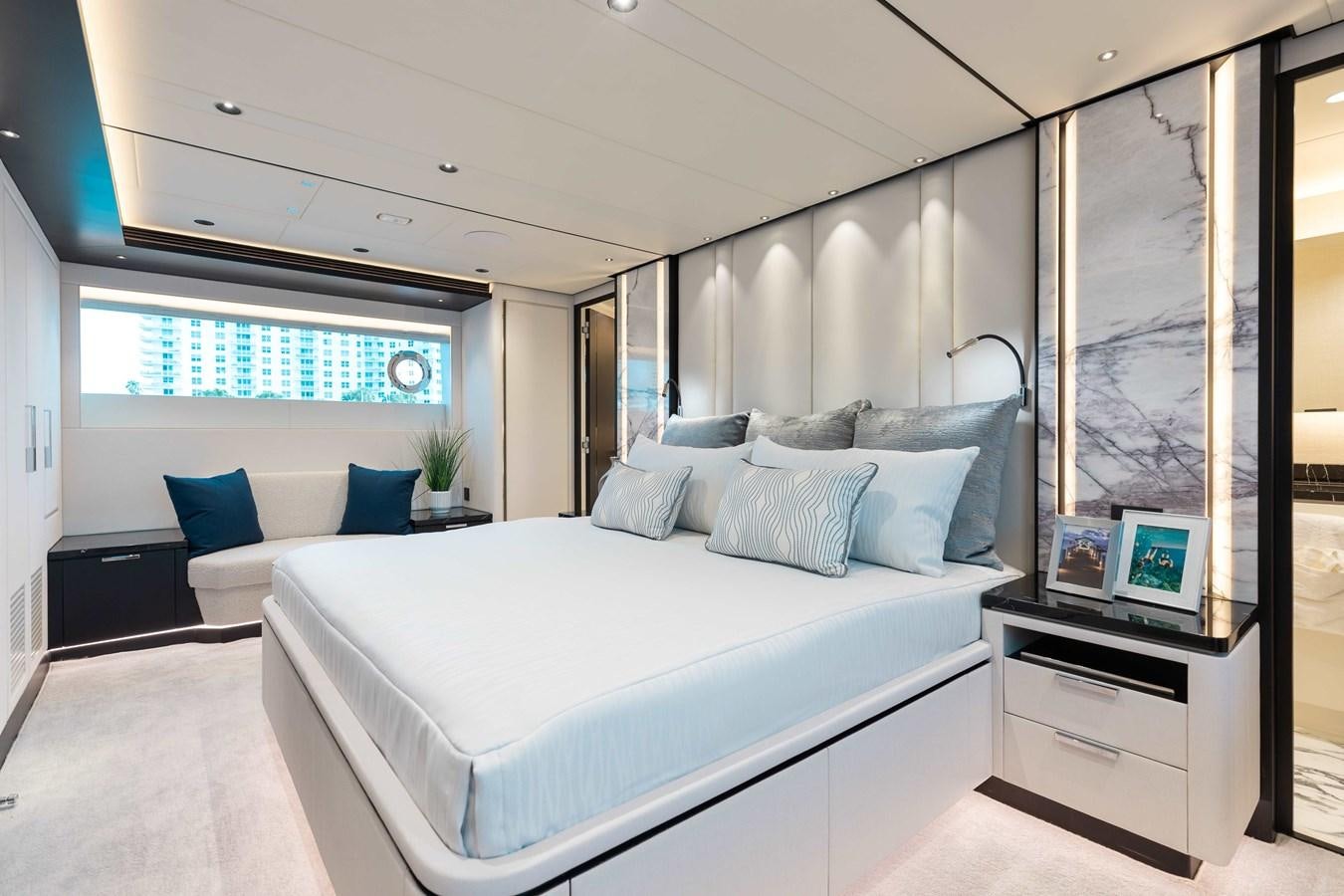 a large white bed in a room aboard E90 MOTOR Yacht for Sale