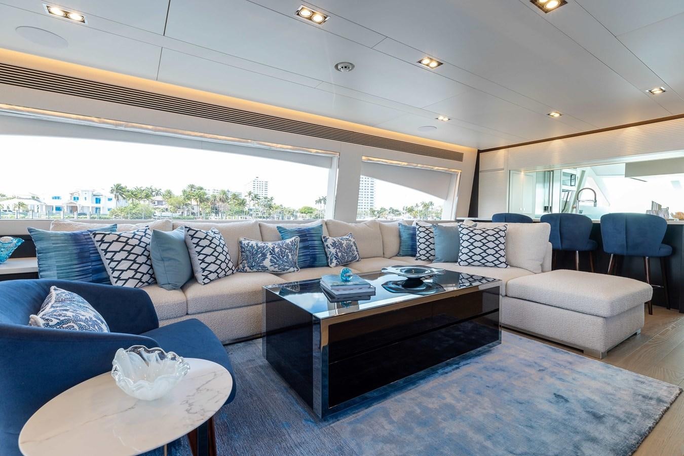 a living room with a large window aboard E90 MOTOR Yacht for Sale