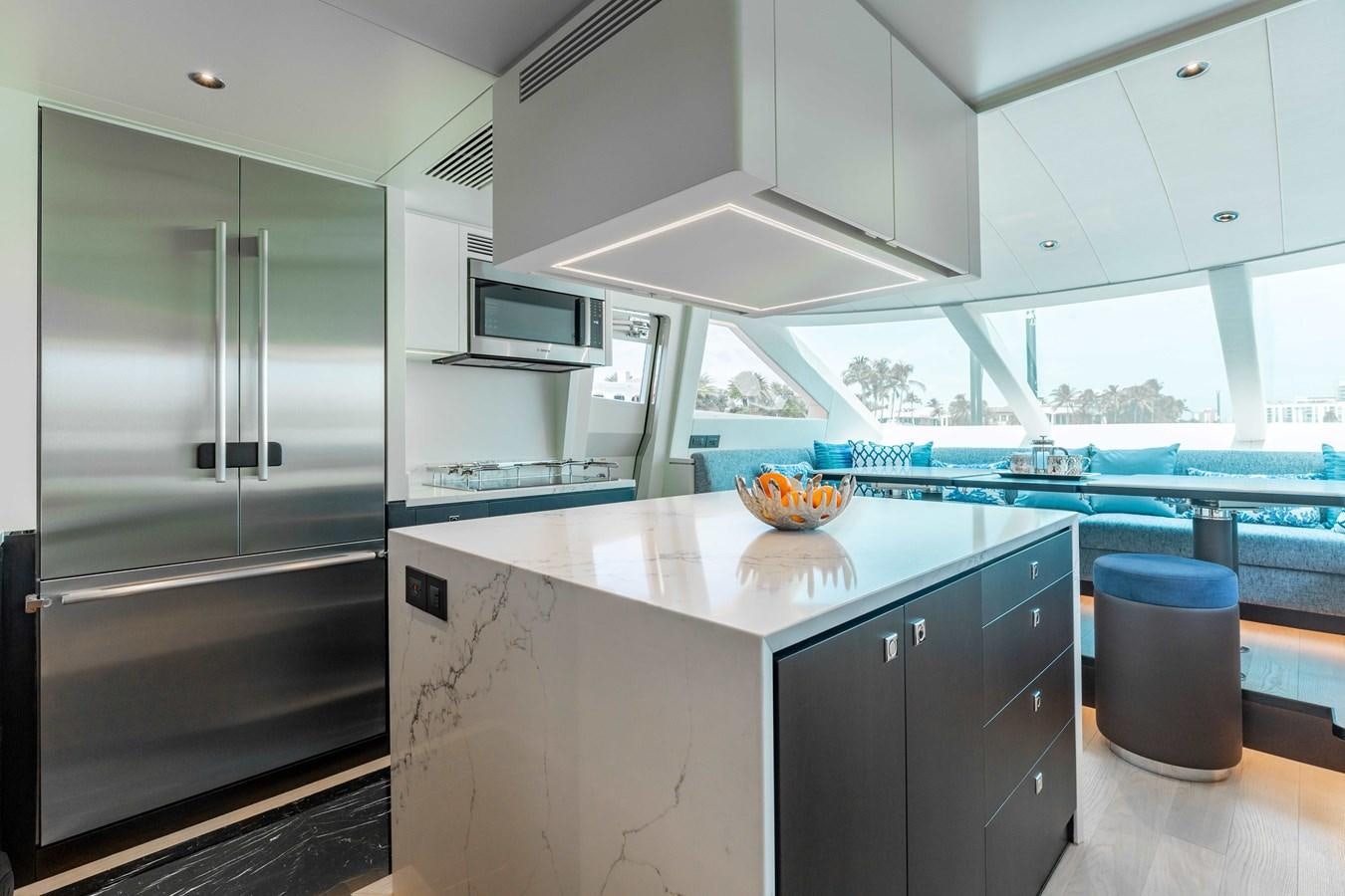 a kitchen with a large island aboard E90 MOTOR Yacht for Sale