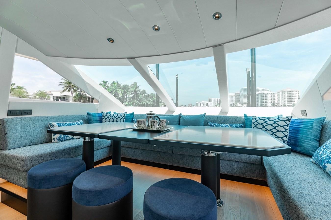 a large table with chairs around it aboard E90 MOTOR Yacht for Sale