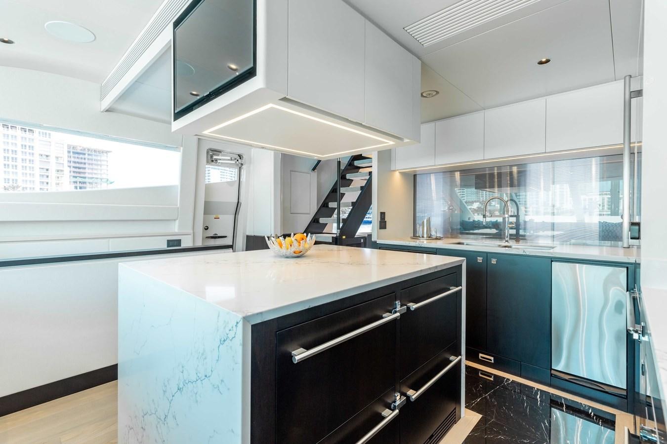 a kitchen with a large island aboard E90 MOTOR Yacht for Sale