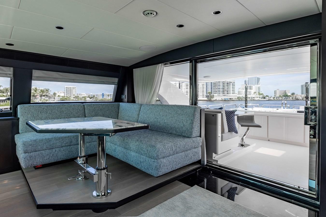 a living room with a couch and a table aboard E90 MOTOR Yacht for Sale
