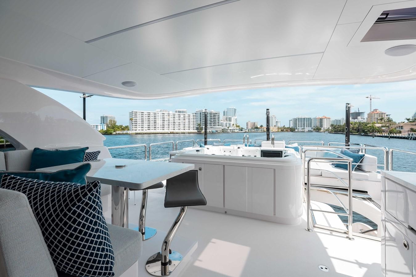 a room with a view of a city and water aboard E90 MOTOR Yacht for Sale