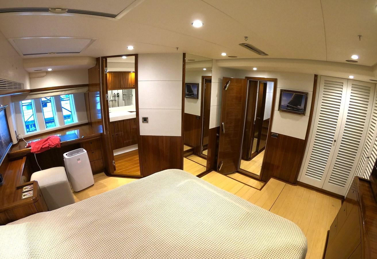 a hotel room with a bed and a tv aboard GUARDIAN ANGEL Yacht for Sale