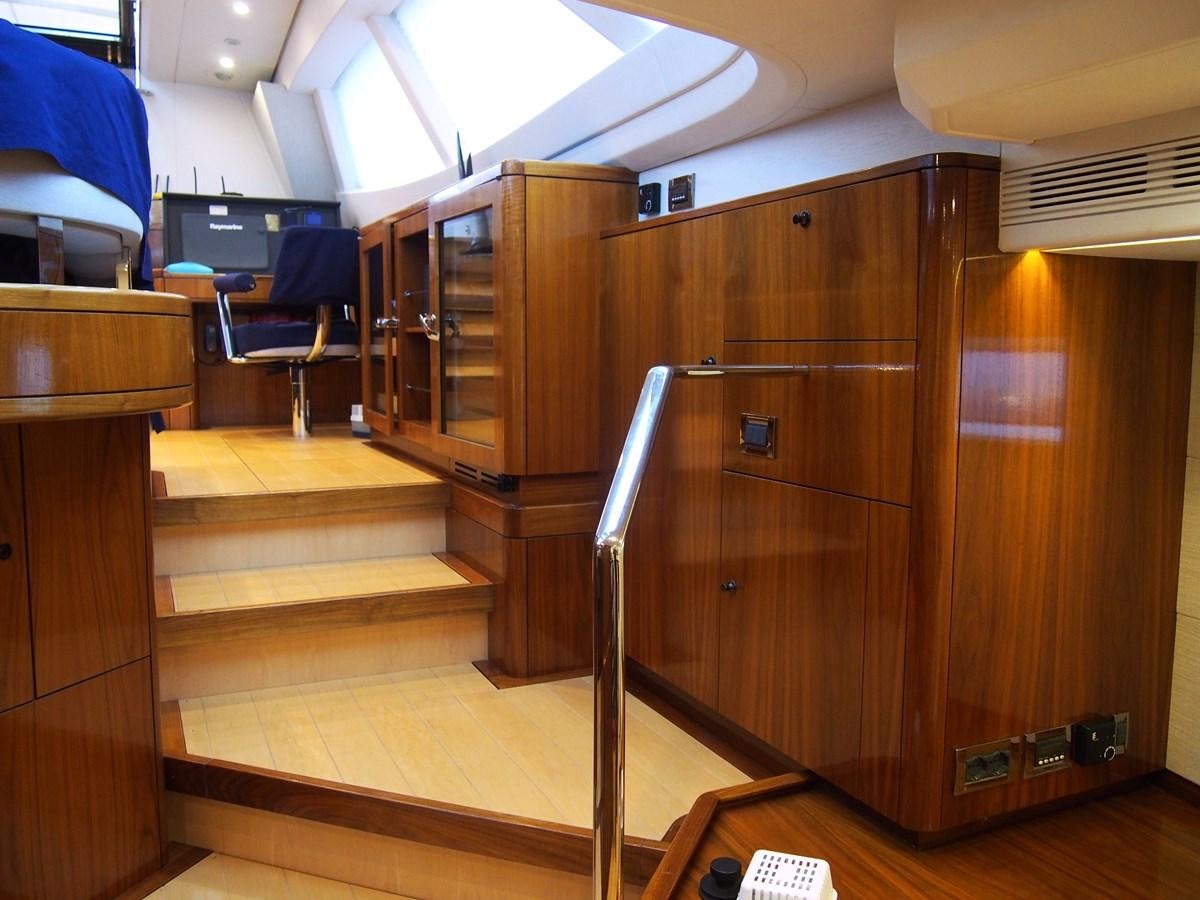 a room with a wood cabinet and a chair aboard GUARDIAN ANGEL Yacht for Sale