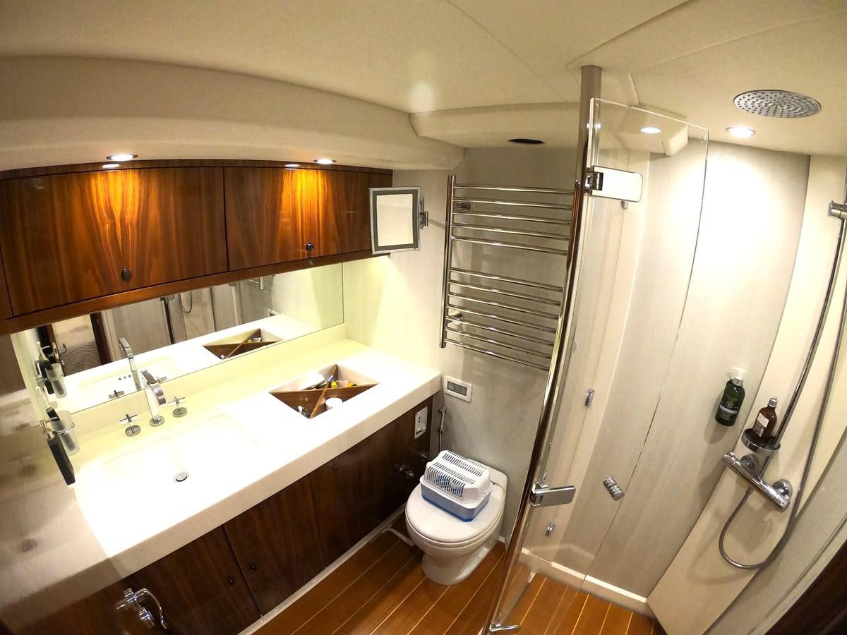 a bathroom with a toilet and sink aboard GUARDIAN ANGEL Yacht for Sale