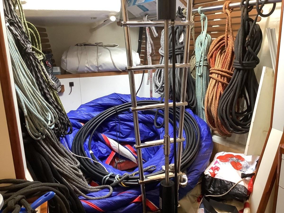 a room with clothes on the wall aboard GUARDIAN ANGEL Yacht for Sale