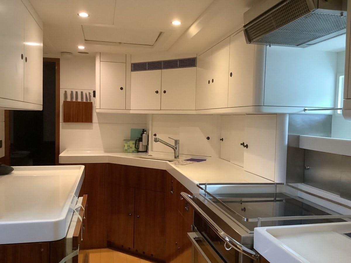 a kitchen with white cabinets aboard GUARDIAN ANGEL Yacht for Sale