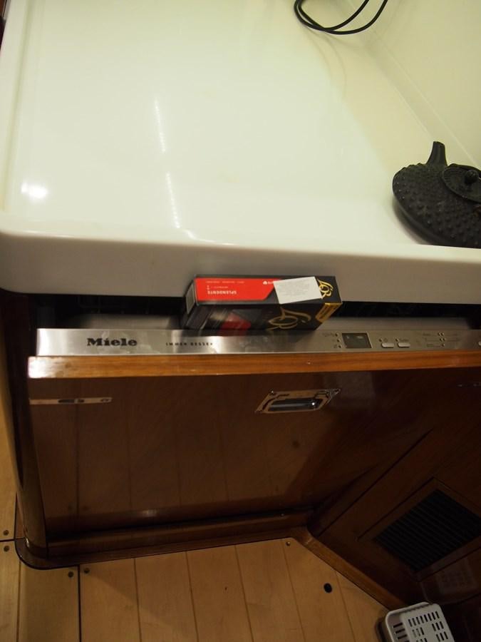 a kitchen sink with a red and white faucet aboard GUARDIAN ANGEL Yacht for Sale