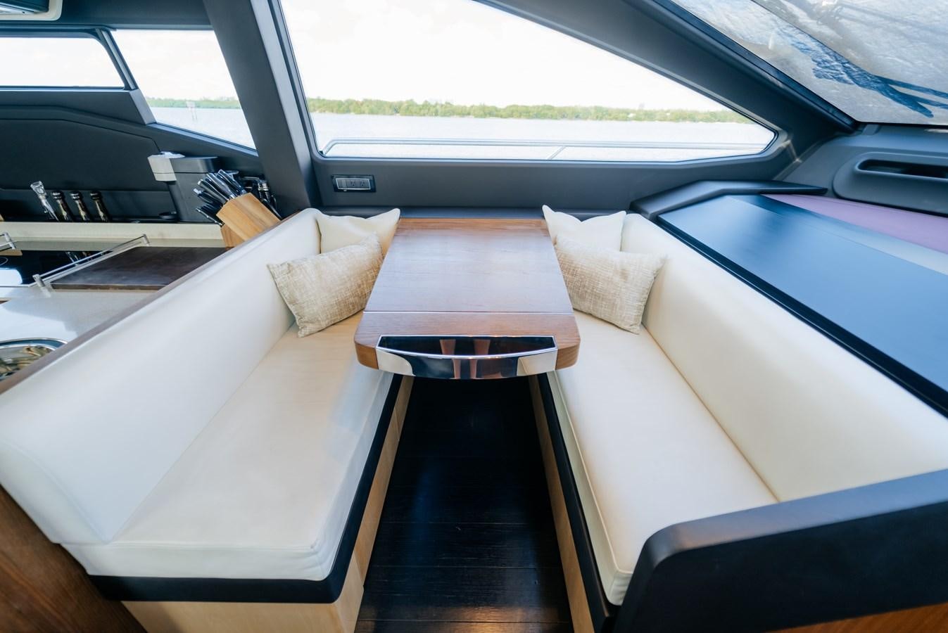 a table and a couch in a car aboard VENTURE Yacht for Sale