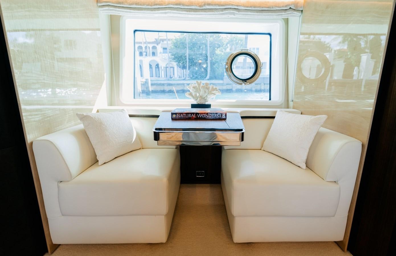 a room with a couch and a coffee table aboard VENTURE Yacht for Sale