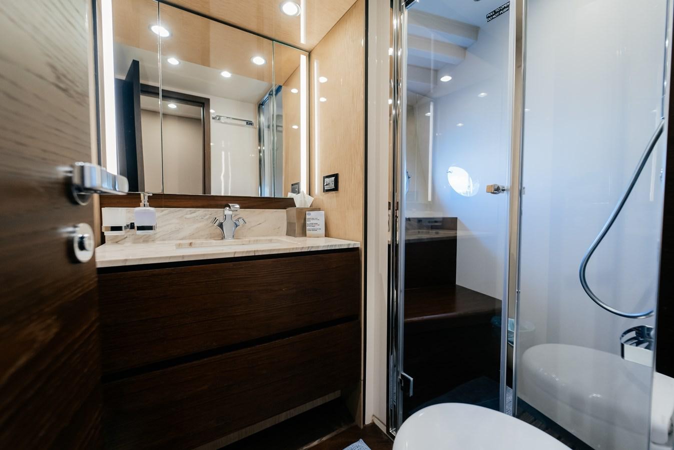 a bathroom with a sink and a mirror aboard VENTURE Yacht for Sale