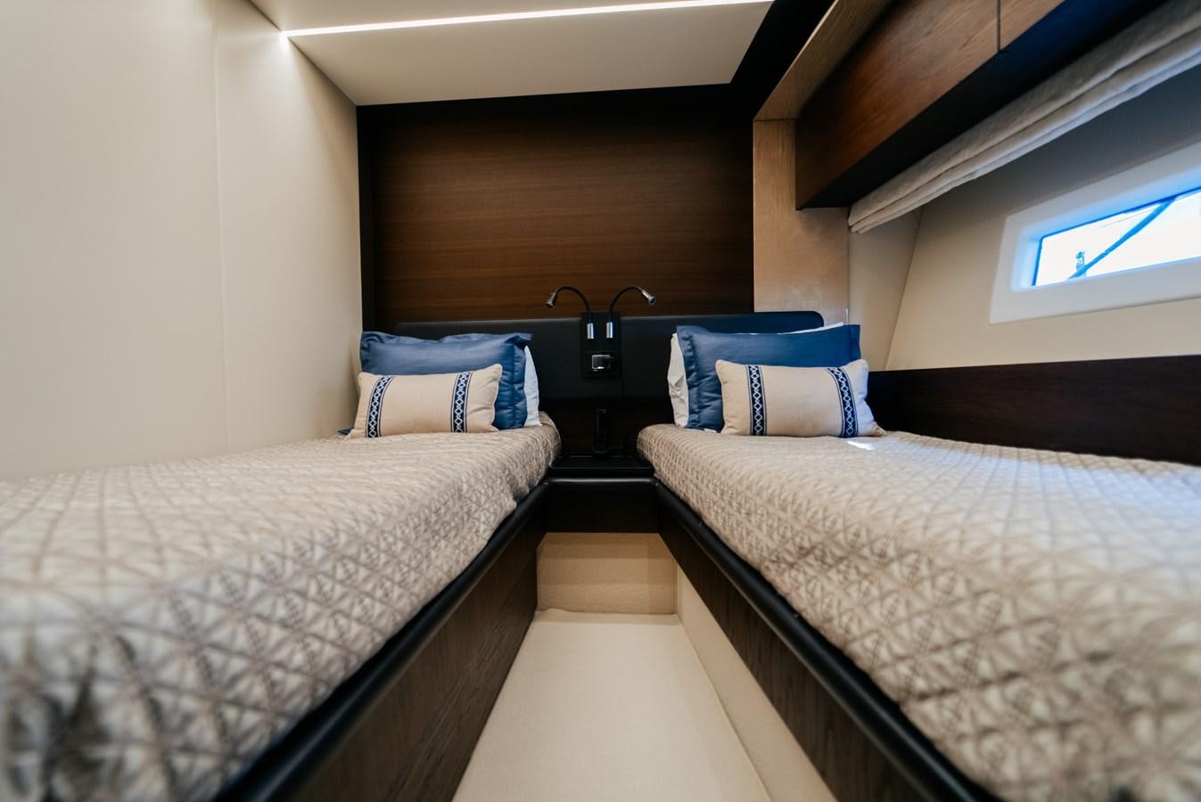 a room with two beds aboard VENTURE Yacht for Sale