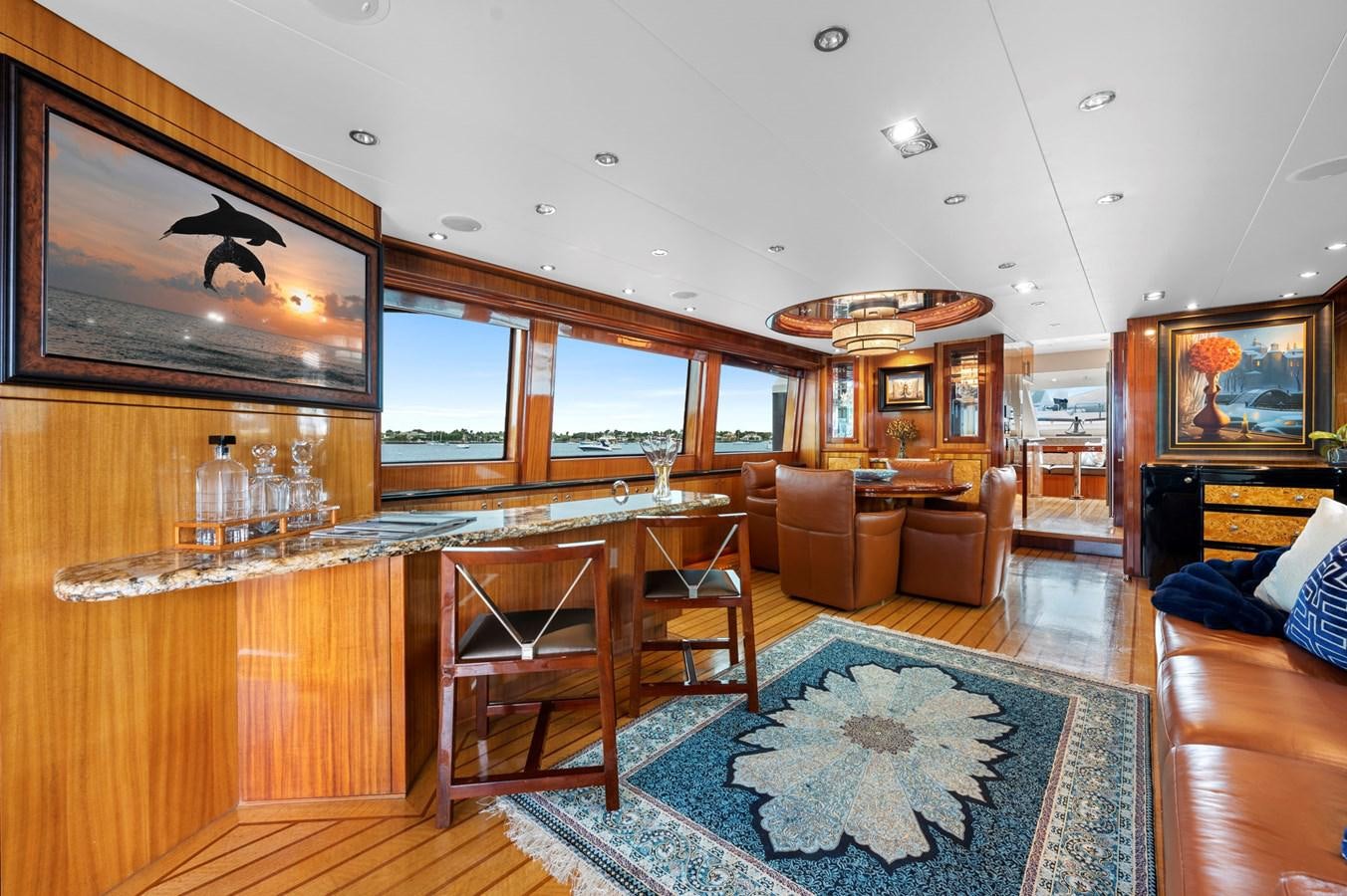 a living room with a large glass window and wood cabinets aboard ENDLESS SUMMER Yacht for Sale