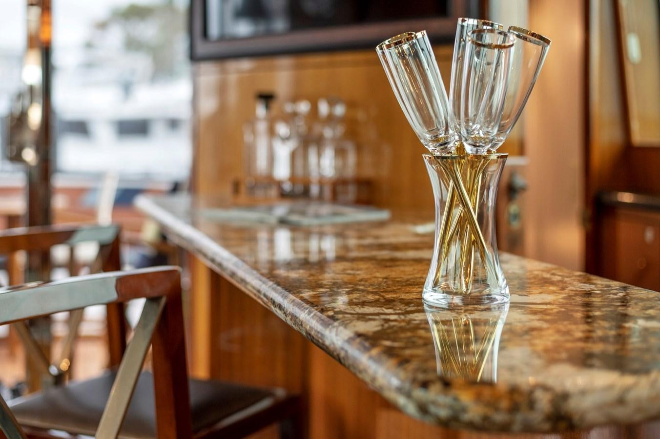 a glass of liquid on a table aboard ENDLESS SUMMER Yacht for Sale