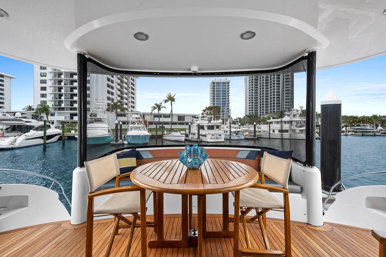a table and chairs on a balcony overlooking a body of water aboard ENDLESS SUMMER Yacht for Sale