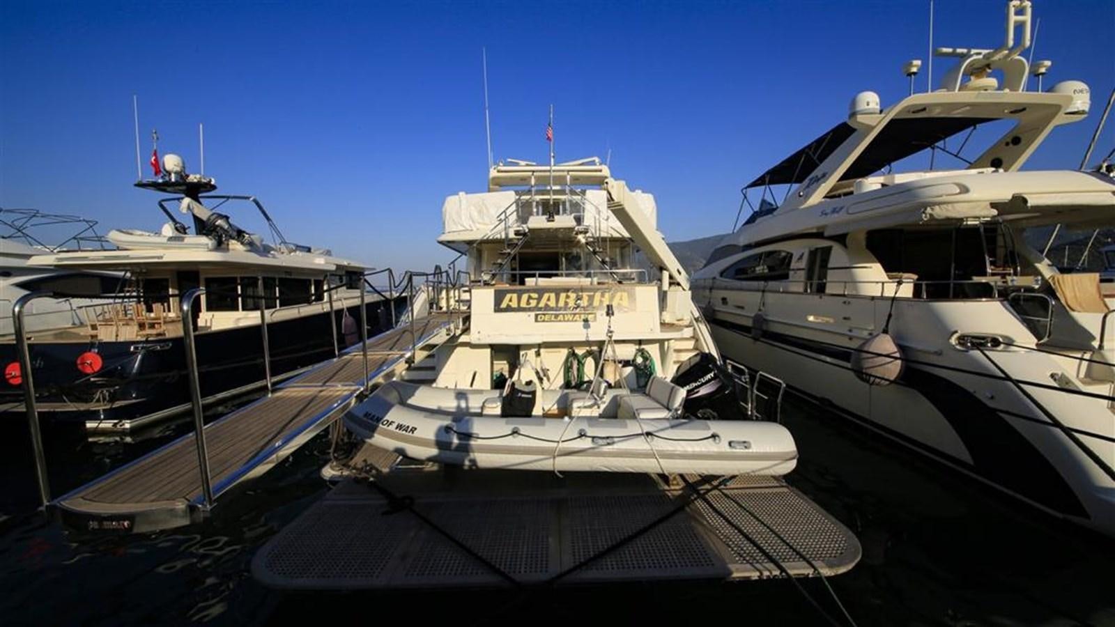 several boats docked at a pier aboard AGARTHA Yacht for Sale