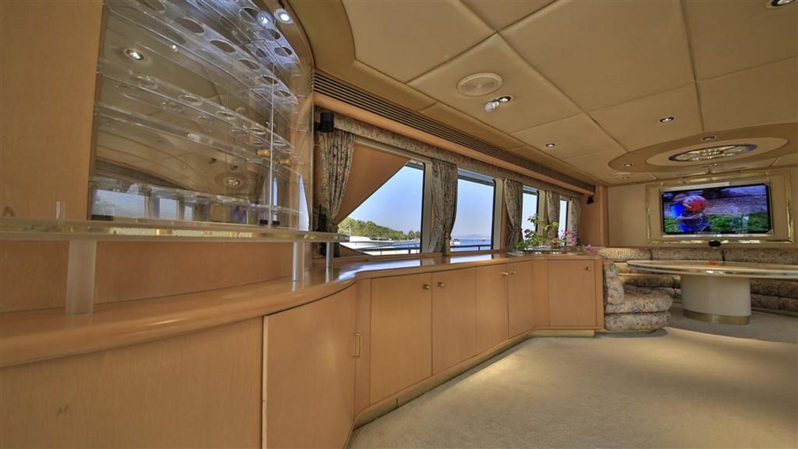 a room with a tv and a couch aboard AGARTHA Yacht for Sale